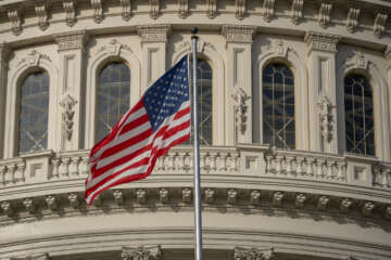 American flag flying outside the U.S. Capitol