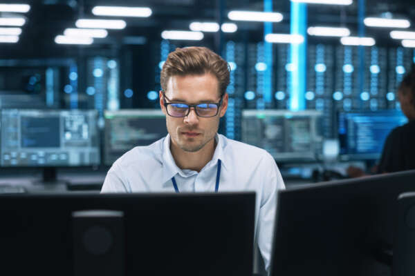 Man in front of computer, cybersecurity cloud