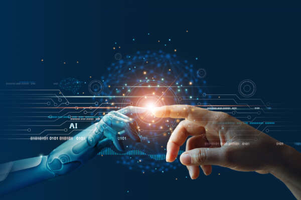 Hands of robot and human touching